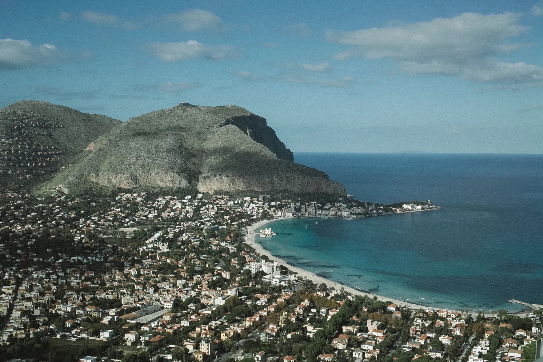 A breathtaking aerial view of Mondello Beach and mountains in Palermo, Sicily.