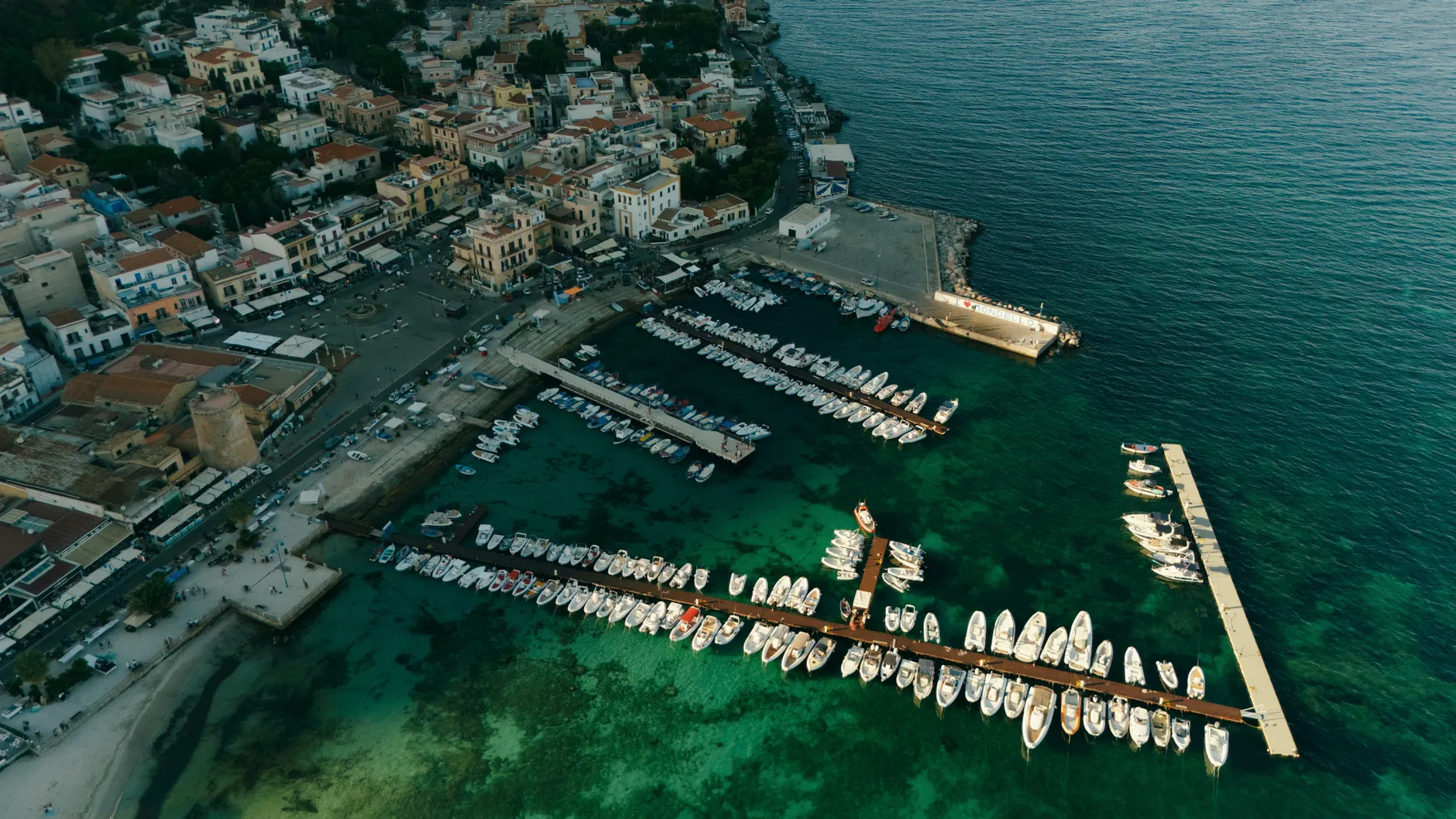 A stunning aerial shot of Mondello marina in Palermo, Sicily showcasing the vibrant seaside and cityscape.